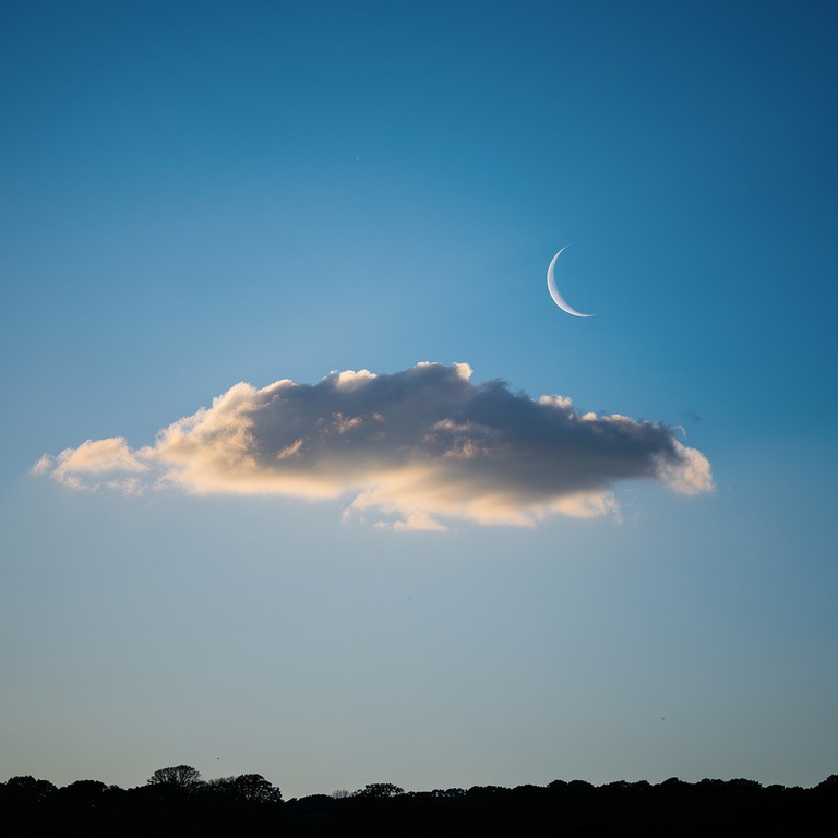 Crescent moon above a single cloud, twilight blue | ShopAyahuascaRetreats