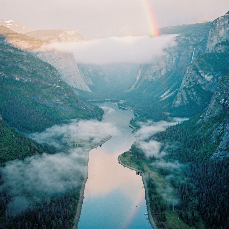 A serene mountain valley at dawn, with misty fog rolling in ... | ShopAyahuascaRetreats
