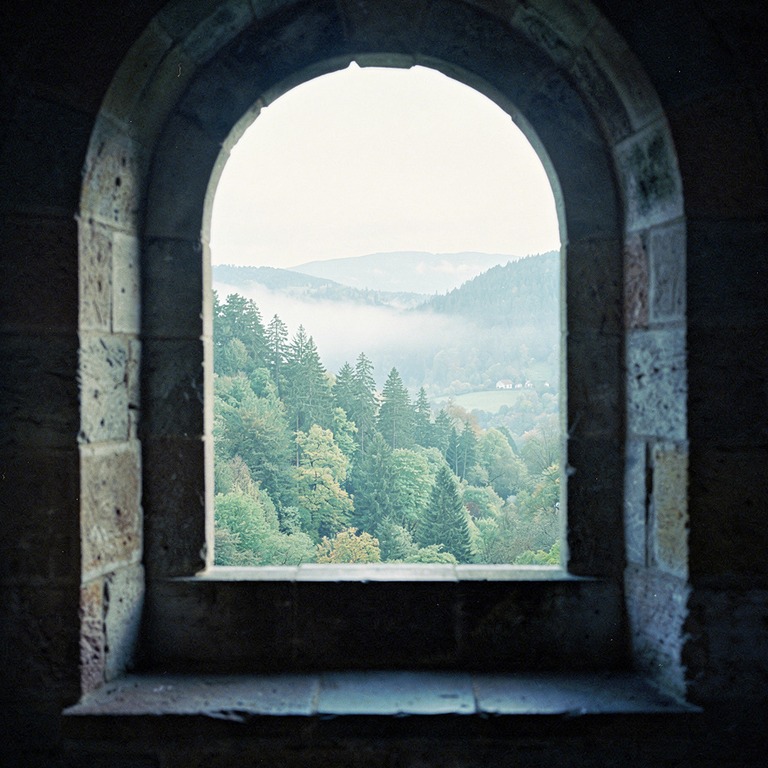 Stone monastery window looking out onto a green forested val... | ShopAyahuascaRetreats